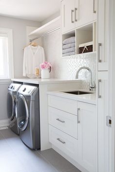 a washer and dryer in a white laundry room