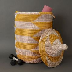 Large size storage basket with hooded lid in yellow and white pattern. Measures approx. 17" diameter, 23" without hood, and 30" height with hood. For storing laundry, toys or 8 throw blankets Woven from grass and recycled plastic ribbons using traditional coil weaving technique. Handmade by Wolof tribe women in Senegal, Africa. --------------------- The Wolof people in Senegal are known for weaving colorful baskets from locally harvested cattail stalks and strips of plastic. They weave handmade Large Basket With Lid, Bead Garland Christmas Tree, Hooded Lids, Senegal Africa, Christmas Tree Beads, Wine Bottle Topper, Colorful Baskets, Grass Basket, Large Storage Baskets