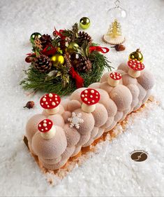 a piece of food with mushrooms on it and christmas decorations in the background, including pine cones