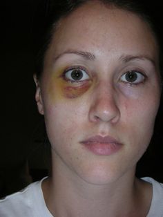 a woman with makeup on her face and yellow eyeliners