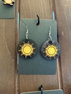 Introducing our charming Wooden Sunshine Earrings, a delightful fusion of nature-inspired design and vibrant energy. Handcrafted with care, these earrings feature intricately carved wooden suns, radiating warmth and cheerfulness. The natural grain of the wood adds a touch of rustic elegance, while the sunburst motif brings a playful touch to any outfit. Lightweight and comfortable to wear, these earrings are perfect for adding a sunny flair to your day or as a thoughtful gift for someone special. Embrace the beauty of nature and bask in the golden glow of these enchanting Wooden Sunshine Earrings. Sunshine Earrings, Wooden Earrings Handmade, Wooden Sun, Sun Jewelry, Sun Earrings, Earthy Jewelry, Wooden Keychain, Beach Earrings, Dog Earrings