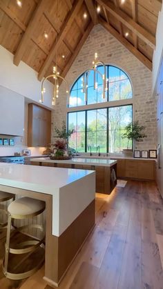 a large kitchen with wooden floors and vaulted ceiling