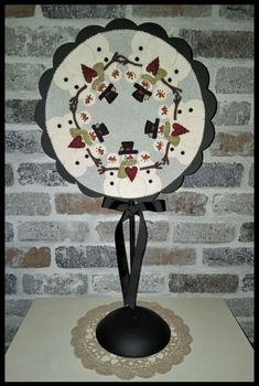 a white and black plate on top of a table next to a brick wall,