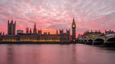 the big ben clock tower towering over the city of london in england at sunset or dawn