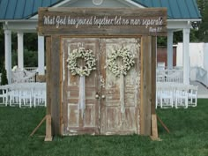 an outhouse decorated with wreaths and flowers on the front door for a wedding