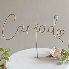 a cake with the word carpdale on it and some flowers in front of it