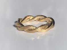 14 K Braided Band.  METAL: 14K Yellow Gold. Can also be made in Rose Gold, White Gold. SIZE: Ladies sizes 4-9. Please indicate your ring size at check out. Please make sure your size is correct as this ring is custom made per size. It can not be resized. Prices subject to change on sizes over 9. DESCRIPTION: This braided band is made in 14K yellow gold and is perfect for stacking. Wear it alone or buy one each in white, rose, and yellow gold and wear them all together! The shank is beautifully d Braided Wedding Ring, Braided Wedding Rings, Braided Ring, Band Metal, Rose Gold White, Stackable Ring, Stackable Rings, White Rose, Band Rings