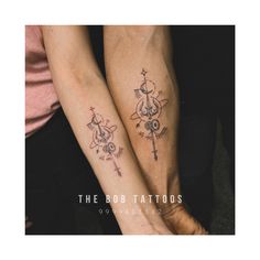 two people holding hands with tattoos on their arms and the words, the bob tattoo