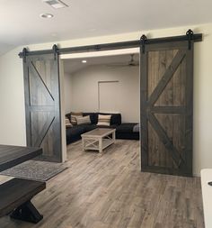 a living room filled with furniture and sliding doors