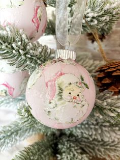 a pink ornament hanging from a christmas tree