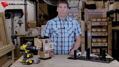 a man standing in front of a table with two drillers and tools on it