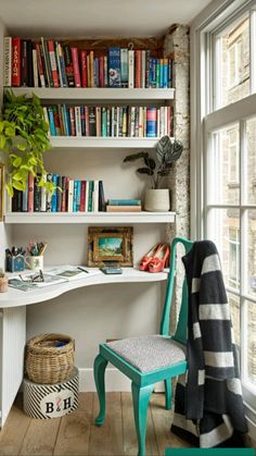 a room that has some books on the shelves and a chair in front of it