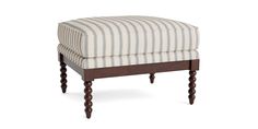 a striped ottoman sitting on top of a wooden frame