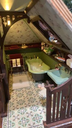 a dollhouse bathroom with green bathtub and sink in it's attic room