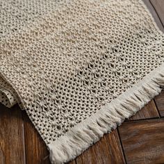 a close up of a rug on a wooden floor