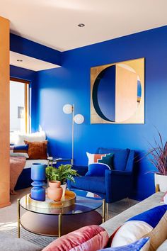 a living room with blue walls and furniture