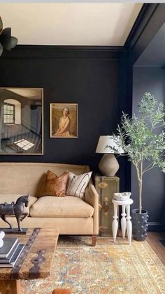 a living room filled with furniture and paintings on the wall