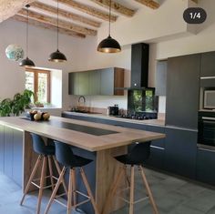 a kitchen with an island and bar stools