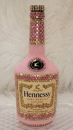 a bottle of hennesy pink gin on a white furnishing background with gold trimmings