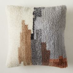 a decorative pillow with multiple colors on the front and back, made out of wool