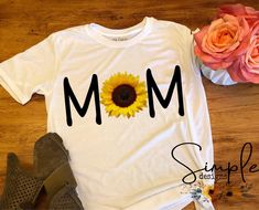 a t - shirt that says mom with a sunflower on it