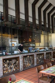 a restaurant with wood stacked on the counter