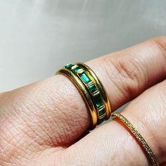 Modern Yellow Gold Emerald Ring, Modern Emerald Rings With Baguette Cut, Modern Baguette Cut Emerald Ring For May Birthstone, Modern Emerald Ring With Polished Finish, Modern Baguette Cut Emerald Ring, Modern Green Geometric Jewelry, Modern Green Emerald Ring With Polished Finish, Art Deco Emerald Ring For May Birthstone, Modern Green Emerald Ring