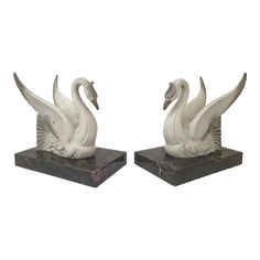 pair of white swans on marble bases