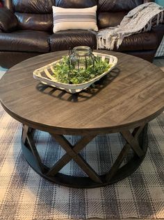 a brown leather couch sitting next to a table with a tray on top of it