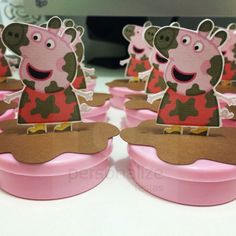 several peppa pig shaped cupcakes sitting on top of a pink container