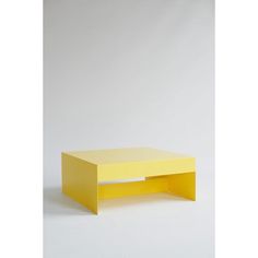 a yellow coffee table sitting on top of a white floor