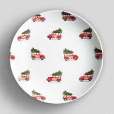 a white plate with red cars and christmas trees on it