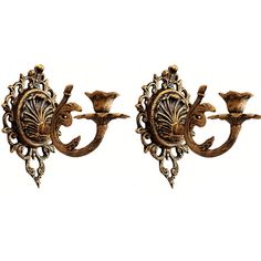 two wall sconces with ornate designs on them