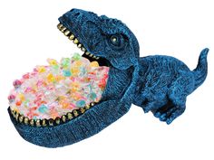 a toy dinosaur eating cereal out of a blue bowl with it's mouth open