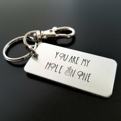 a metal keychain that says, you are my hole in one on it