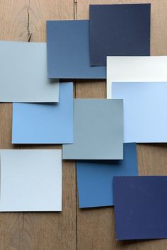 blue and white paint samples laid out on a wooden surface