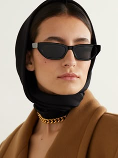 SAINT LAURENT Eyewear's retro-inspired cat-eye sunglasses are designed with sleek, angular frames. Made in Italy from black acetate, they have tonal lenses and silver-tone logos at the hinges. 90s Style Sunglasses, French Sunglasses, Black Sunnies, Sleek Sunglasses, Ysl Sunglasses, French Luxury Brands, Best Sunglasses, Winter Weekend, Dark Sunglasses