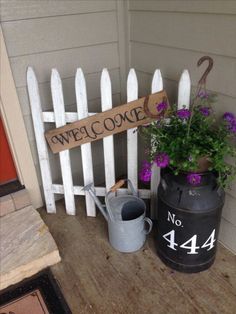 a white picket fence sitting next to a potted plant