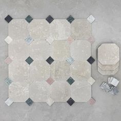 an aerial view of a white and black tile floor with various tiles on the ground