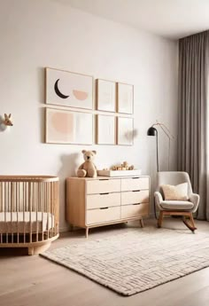 a baby's room with a crib, rocking chair and pictures on the wall