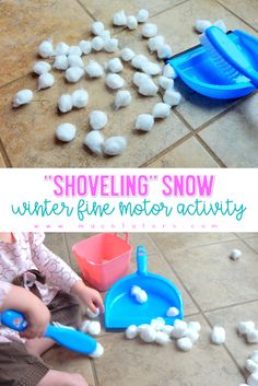 a child playing with snowballs on the floor and in front of it is a blue shovel