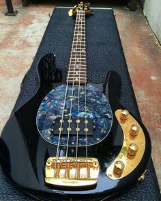 a black and gold guitar sitting on top of a table