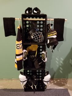 a hockey goalie's helmet and glove rack in the corner of a room