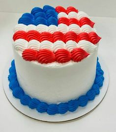 an american flag cake with red, white and blue icing on a platter