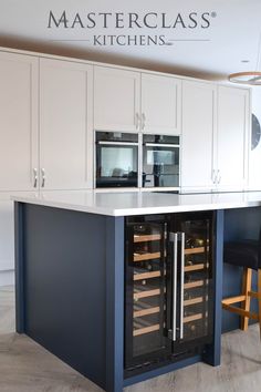 a kitchen with an island and wine cooler in it