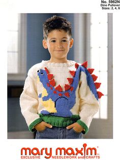 a young boy is wearing a sweater with spikes on it and has his hands in his pockets