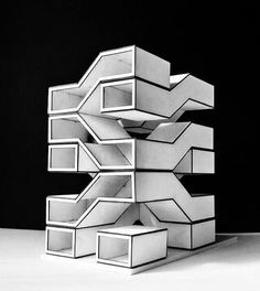 a stack of white boxes sitting on top of a table