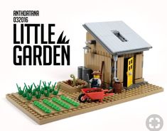 there is a small toy house made out of legos and it has a man with a wheelbarrow in front of it