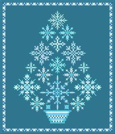 a cross stitch christmas tree with snowflakes