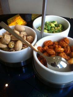 three bowls filled with different types of food on top of a table next to each other